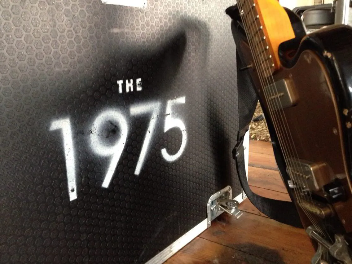 The 1975 flight case and guitar
