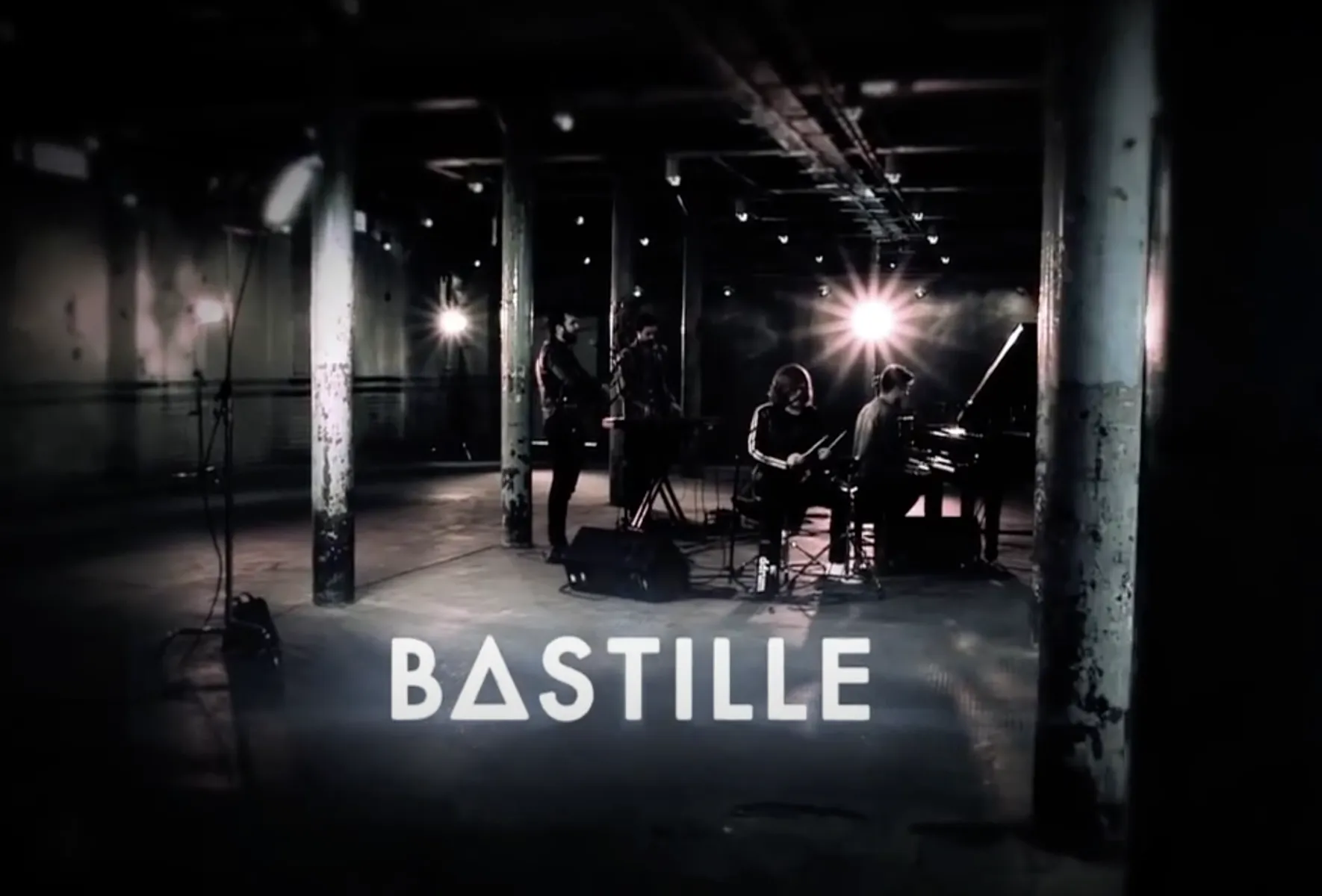 Bastille performing in a warehouse session